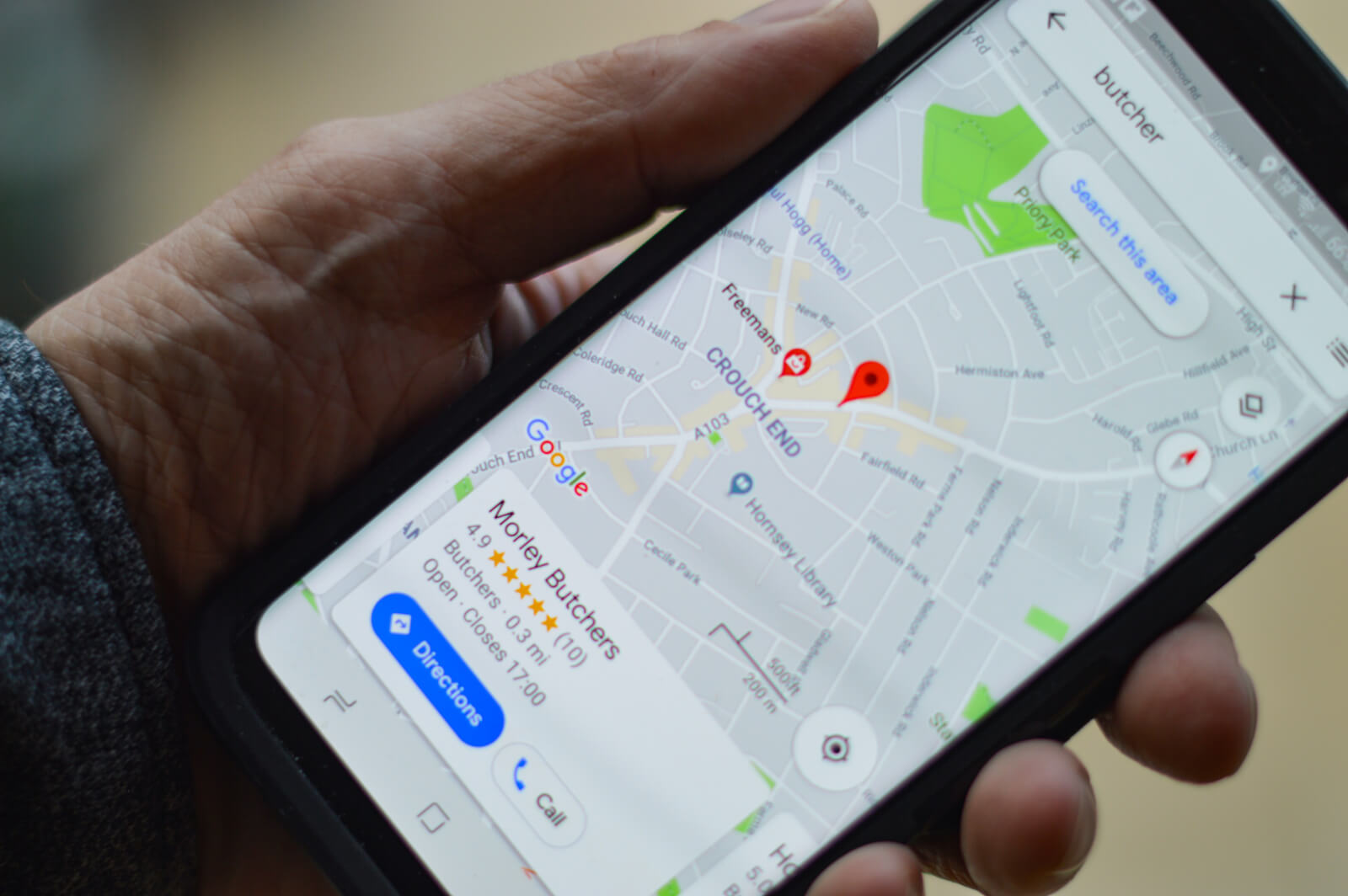 Homeowner searching for a local contractor on a phone
